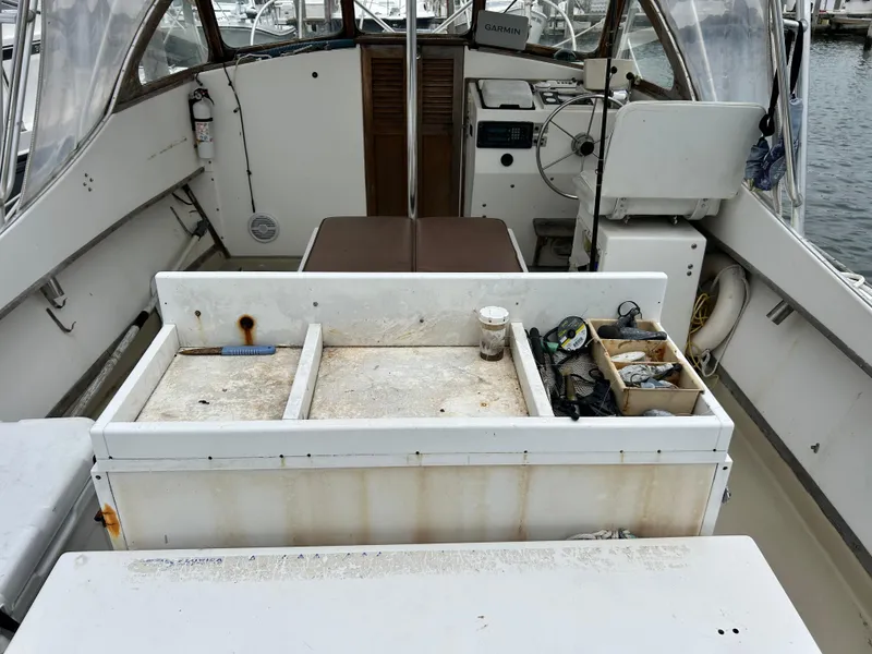 Slide: The Image of 1991 Fortier 26 Hard Top boat interior with fishing gear and equipment. - 6