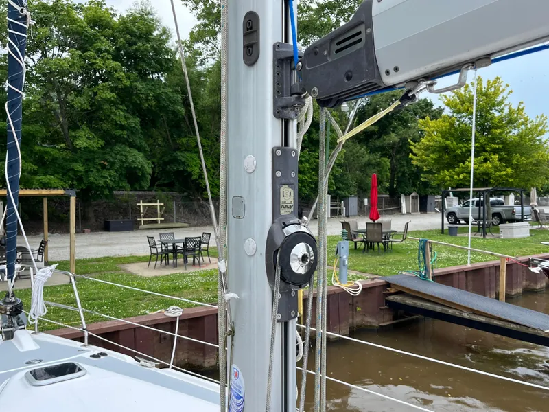 Slide: The Image of Sailboat mast and rigging of 2004 Hunter 41 at dockside with outdoor seating. - 11