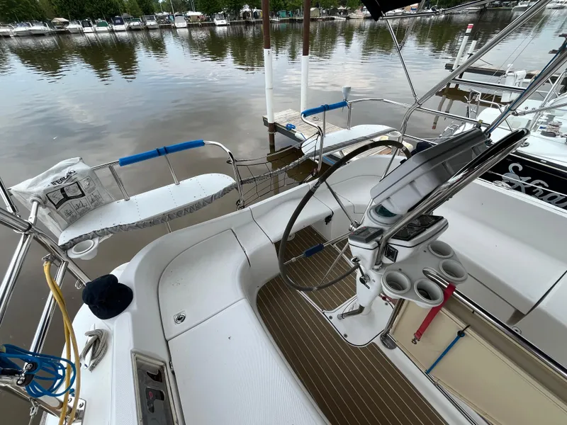 Slide: The Image of Cockpit of 2004 Hunter 41 sailboat with steering wheel and marina view. - 15