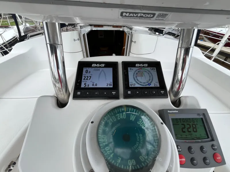 Slide: The Image of Helm of 2004 Hunter 41 sailboat with navigation instruments and compass. - 17