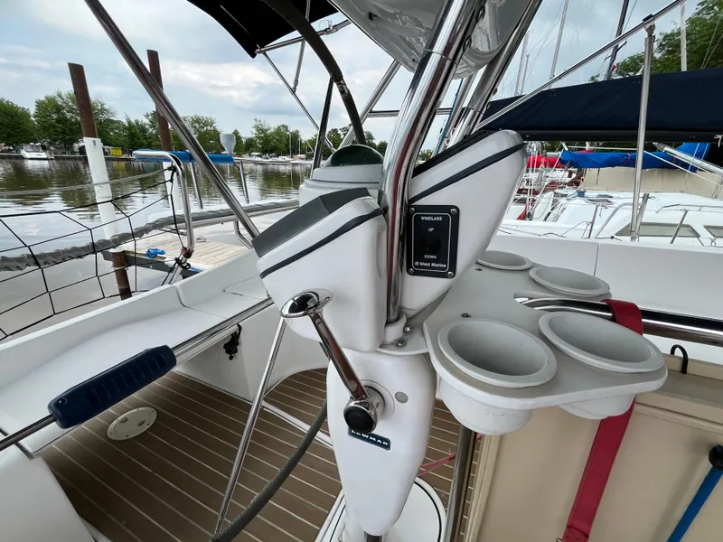 Slide: The Image of Cockpit of 2004 Hunter 41 sailboat with steering wheel and cup holders. - 18