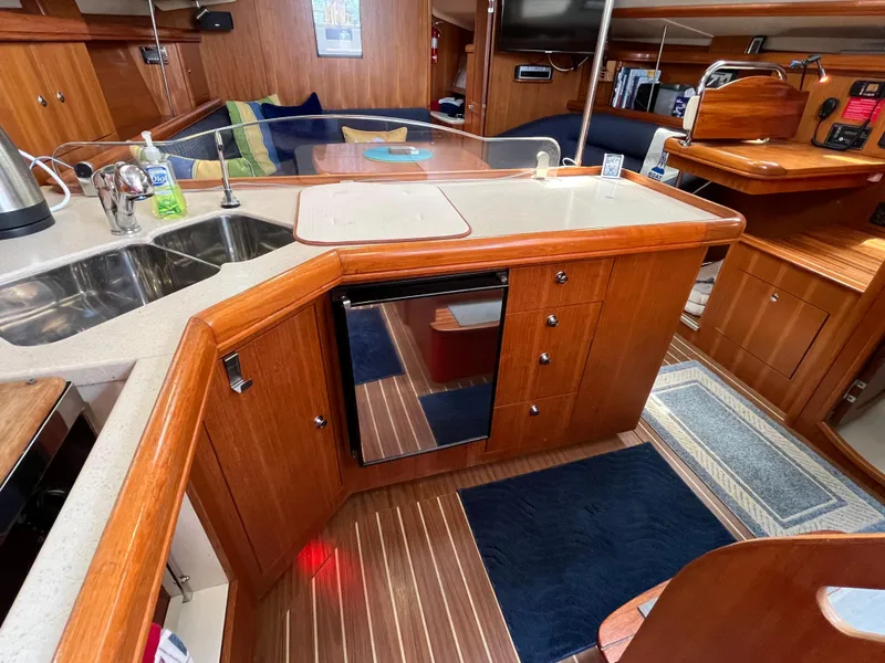 Slide: The Image of Interior of 2004 Hunter 41 sailboat kitchen with wood cabinetry and modern appliances. - 25