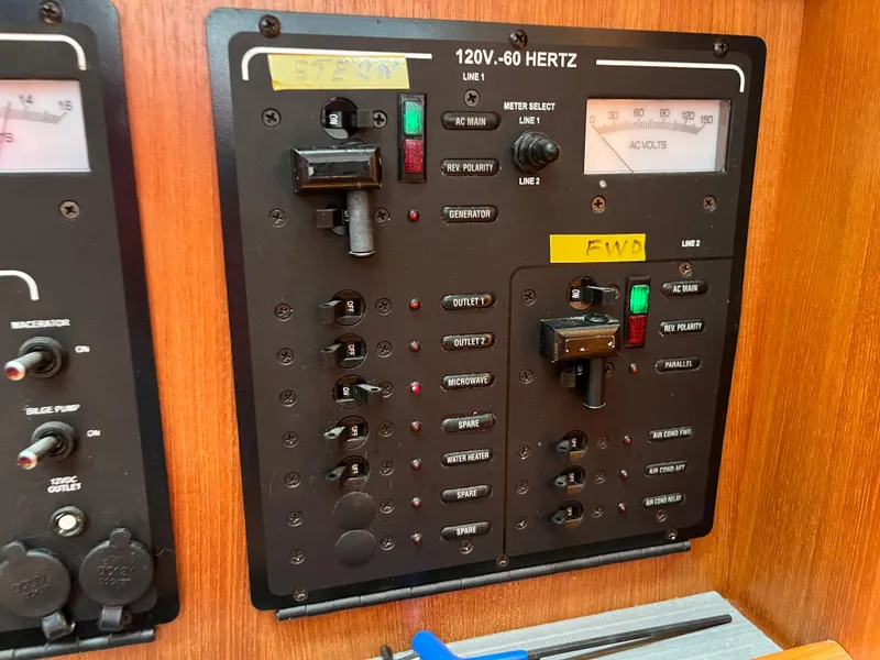 Slide: The Image of Electrical control panel on a 2004 Hunter 41 boat, featuring switches and voltage meters. - 29
