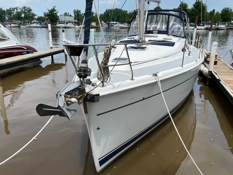 Slide: The Image of 2004 Hunter 41 sailboat docked at a marina, featuring sleek design and modern rigging. - 3