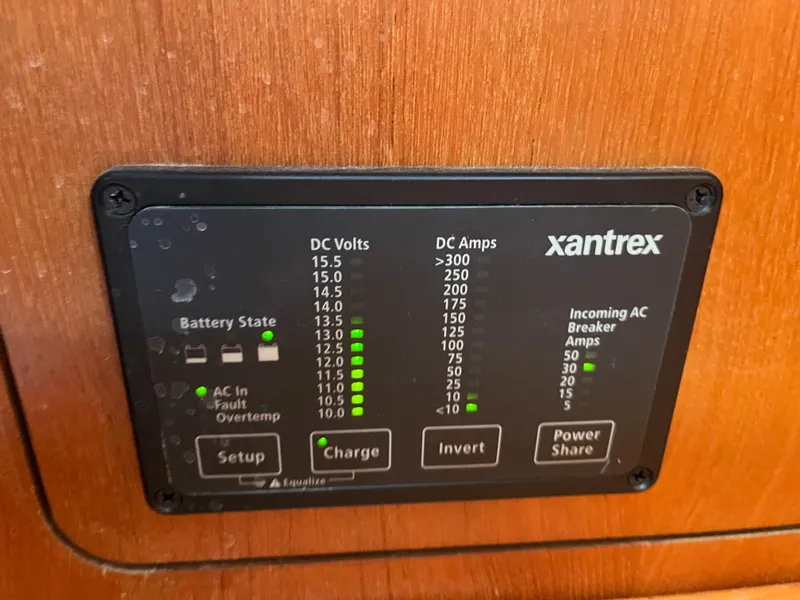 Slide: The Image of Xantrex power panel on 2004 Hunter 41 boat, displaying DC volts and amps. - 30