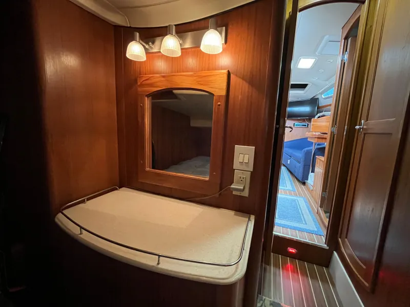 Slide: The Image of Interior of 2004 Hunter 41 yacht with wooden cabinetry and mirror. - 33