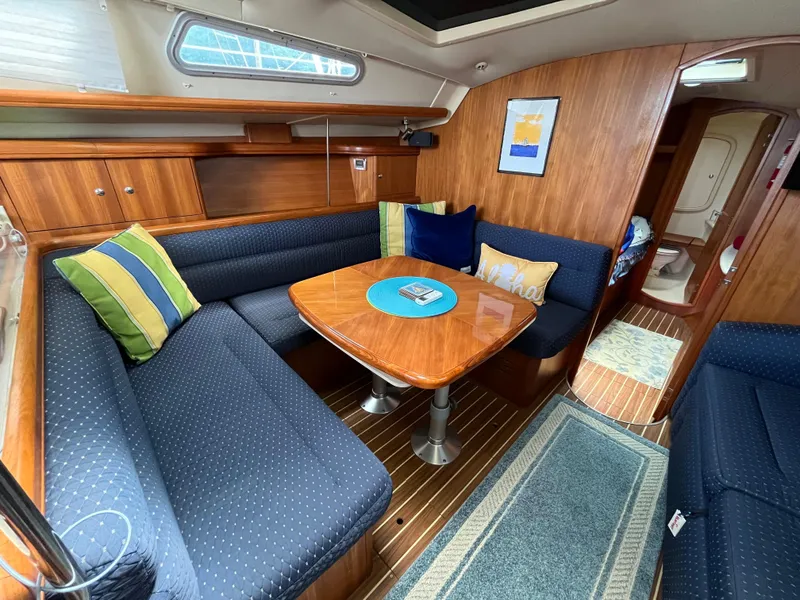Slide: The Image of Interior of 2004 Hunter 41 sailboat with cozy seating and wooden table. - 37