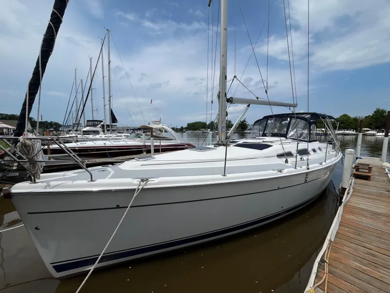 Slide: The Image of 2004 Hunter 41 sailboat docked at marina under blue sky. - 4