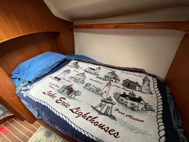 Slide: The Image of Cozy cabin bed in 2004 Hunter 41 sailboat with Lake Erie lighthouses blanket. - 41