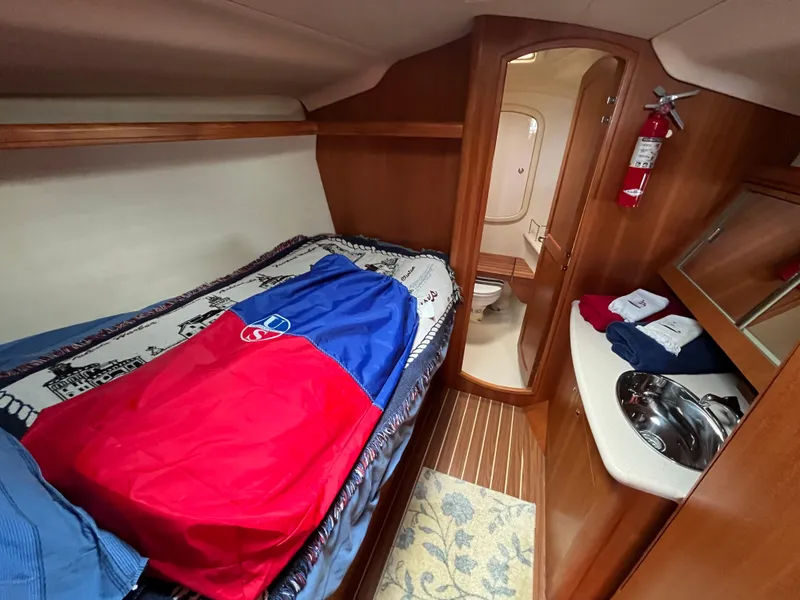 Slide: The Image of Cozy cabin interior of 2004 Hunter 41 sailboat with bed, sink, and bathroom. - 43