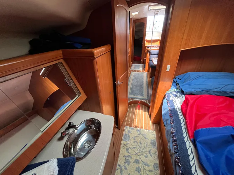 Slide: The Image of Interior of 2004 Hunter 41 sailboat with wood finish and cozy sleeping area. - 45