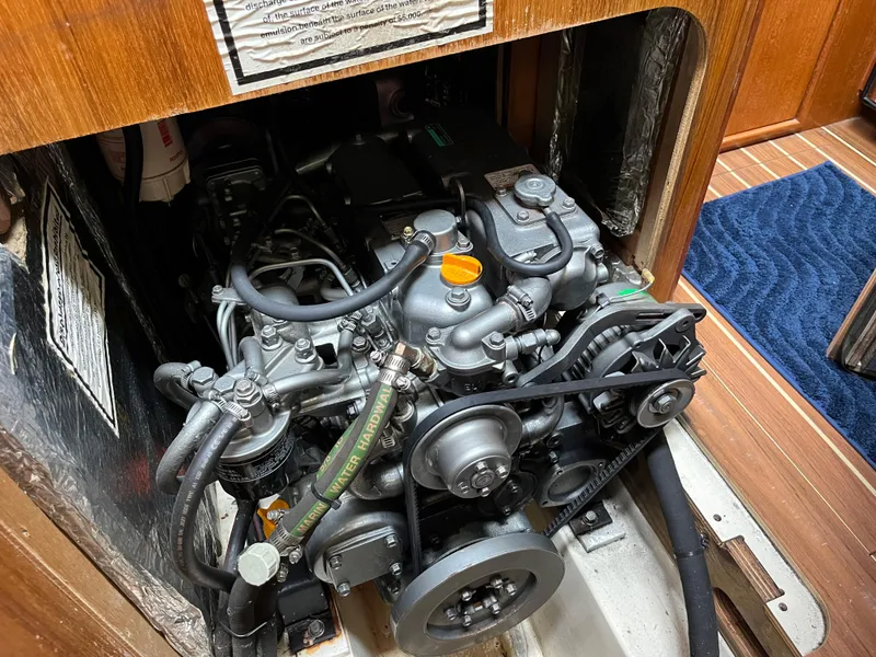 Slide: The Image of Engine compartment of a 2004 Hunter 41 sailboat, showcasing detailed mechanical components. - 49