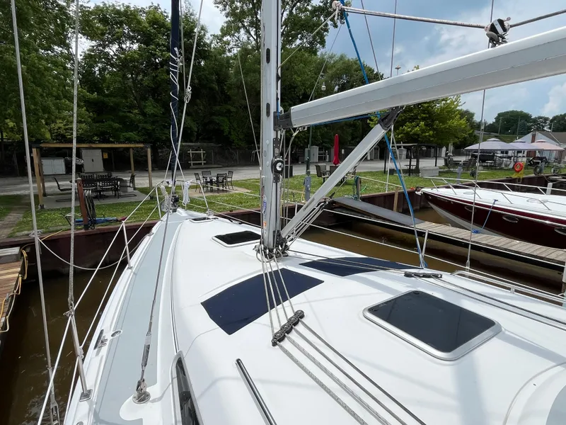 Slide: The Image of Sailboat Hunter 41, 2004 model, docked at marina with lush greenery background. - 7