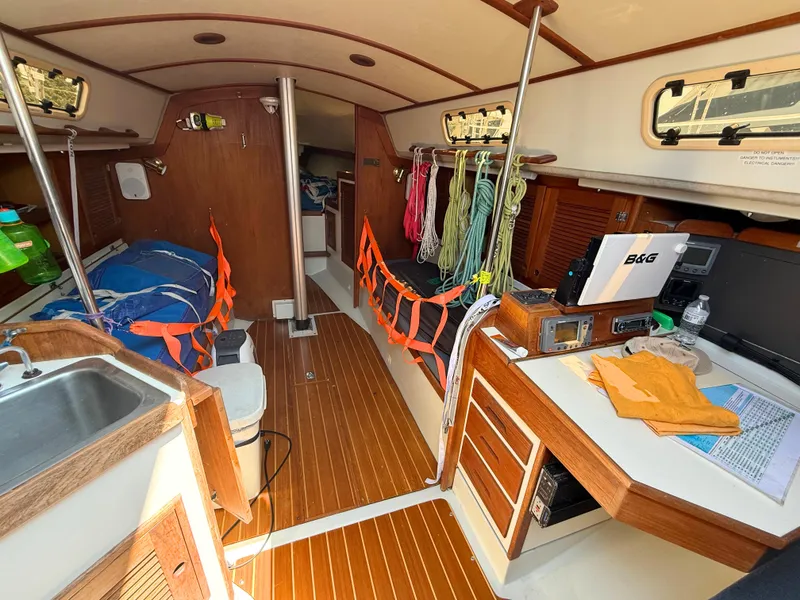 Slide: The Image of Interior of 1991 Tartan Thomas 35 sailboat with wood finish and nautical equipment. - 20