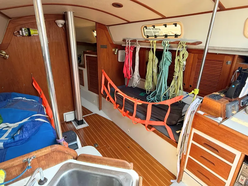 Slide: The Image of Interior of 1991 Tartan Thomas 35 sailboat with ropes and wooden cabinetry. - 22