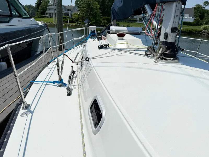 Slide: The Image of Sailboat deck of 1991 Tartan Thomas 35, docked, with rigging and equipment visible. - 6