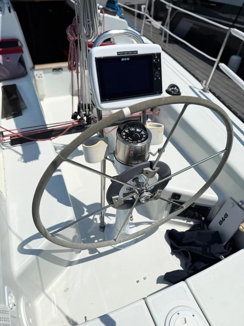 Slide: The Image of Steering wheel and navigation equipment on a 1991 Tartan Thomas 35 sailboat. - 9