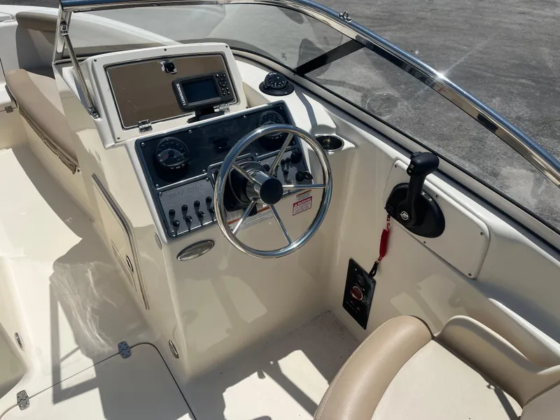 Slide: The Image of 2022 Scout 210 Dorado boat cockpit with steering wheel and control panel. - 10