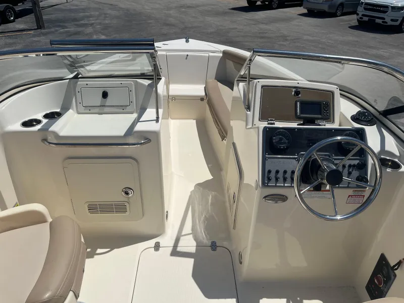 Slide: The Image of 2022 Scout 210 Dorado boat interior with steering wheel and control panel. - 7