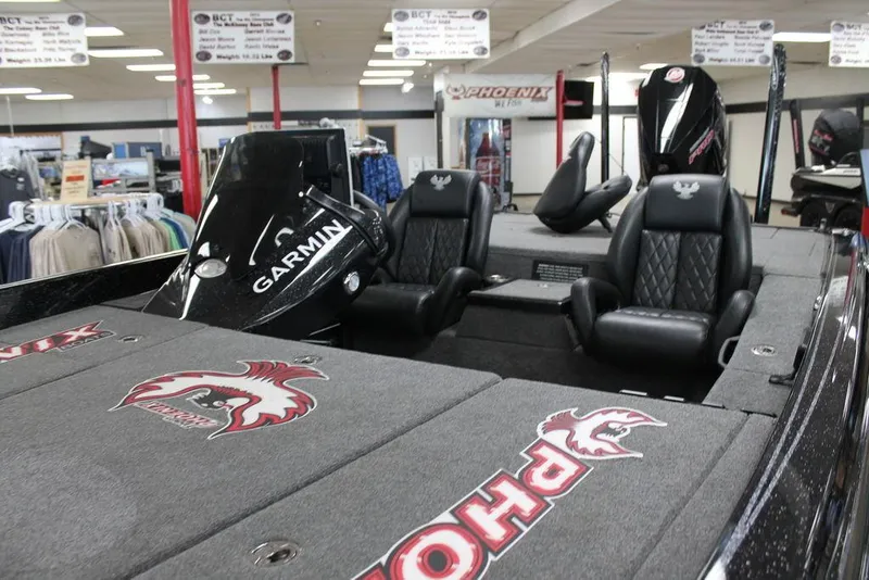 Slide: The Image of 2025 Phoenix 21 XE boat interior with Garmin system and leather seats in showroom. - 11