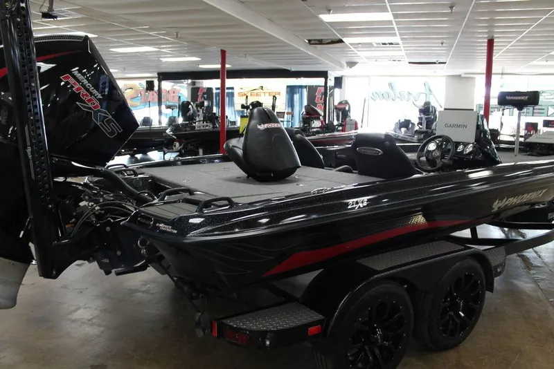 Slide: The Image of 2025 Phoenix 21 XE boat with Mercury Pro XS engine in showroom. - 2