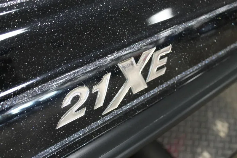 Slide: The Image of Close-up of 2025 Phoenix 21 XE model emblem on a sparkling black surface. - 6