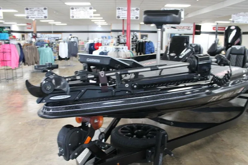 Slide: The Image of 2025 Phoenix 21 XE boat displayed in a showroom with clothing in the background. - 7
