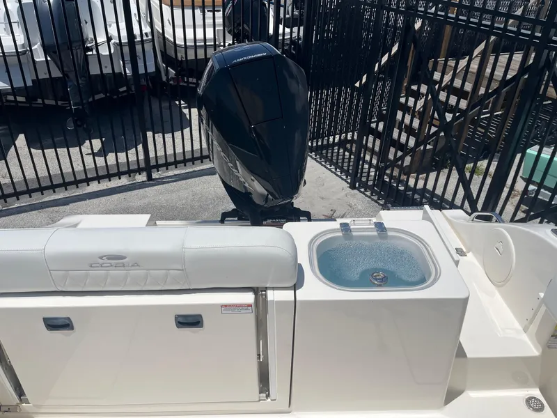 Slide: The Image of 2021 Cobia 237 Center Console boat with Mercury engine and livewell. - 7