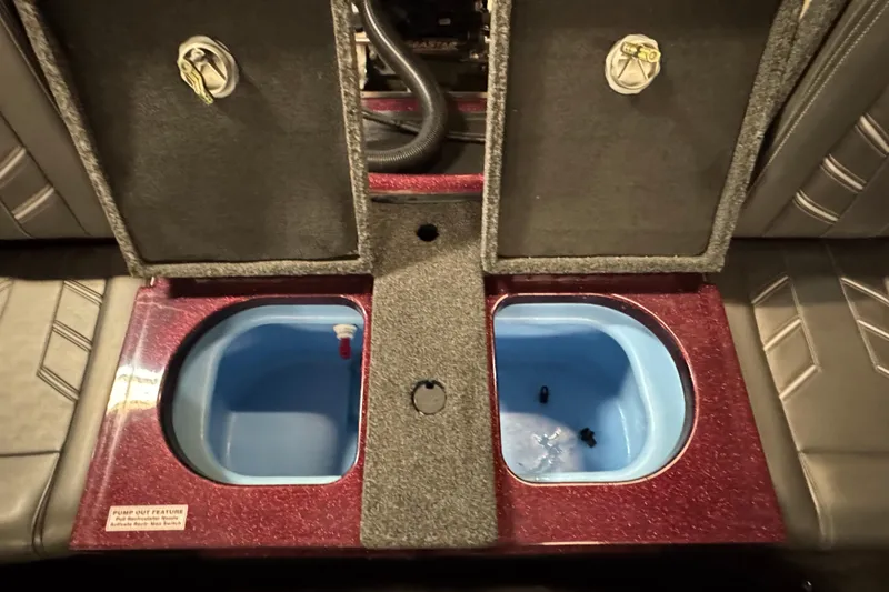 Slide: The Image of 2019 Nitro ZV19 Sport boat storage compartments with open lids and blue interior. - 13