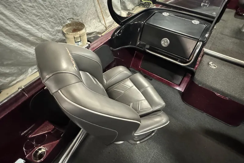 Slide: The Image of 2019 Nitro ZV19 Sport boat interior with gray captain's chair and dashboard. - 14