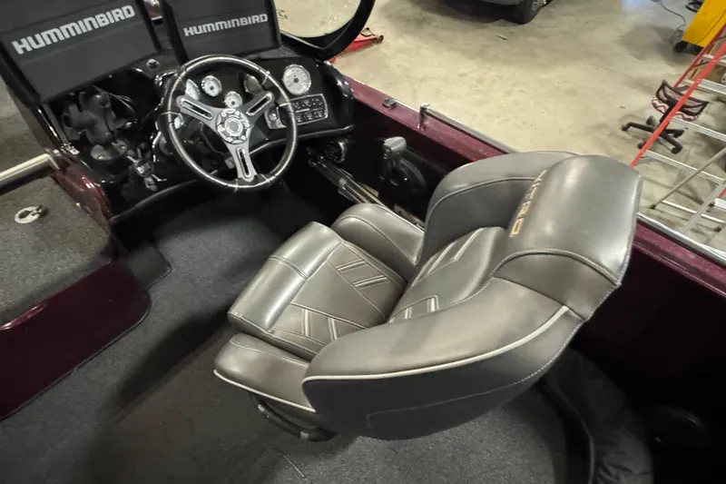 Slide: The Image of 2019 Nitro ZV19 Sport boat interior with steering wheel and gray seating. - 15