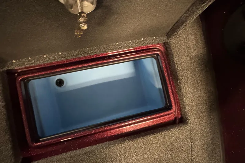 Slide: The Image of 2019 Nitro ZV19 Sport boat storage compartment with open lid, featuring a sleek interior design. - 22