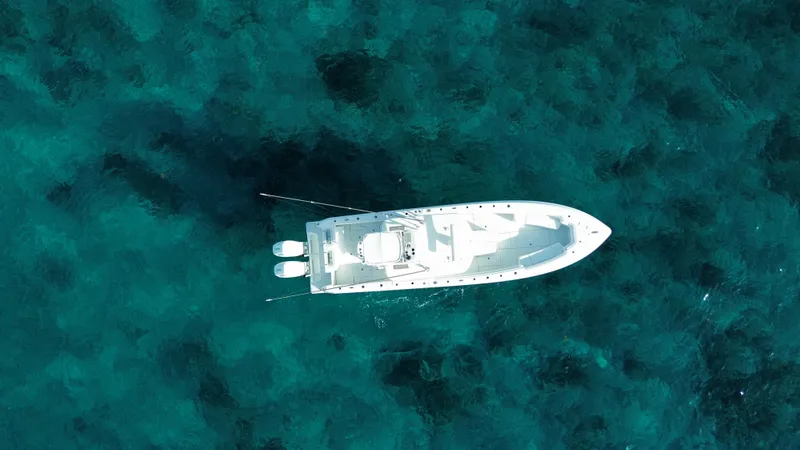 Slide: The Image of Aerial view of 2024 Contender 39 ST boat on clear blue water. - 10