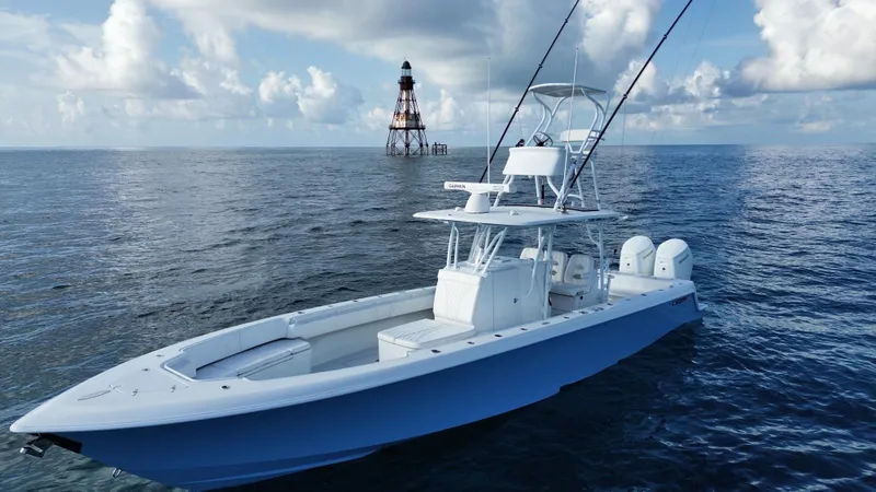 Slide: The Image of 2024 Contender 39 ST boat on open sea near a lighthouse under cloudy sky. - 12