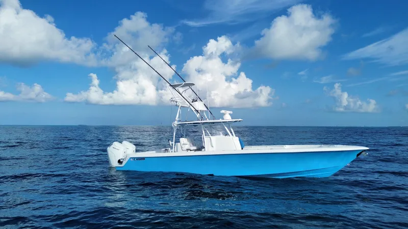 Slide: The Image of 2024 Contender 39 ST boat on open ocean under blue sky. - 13