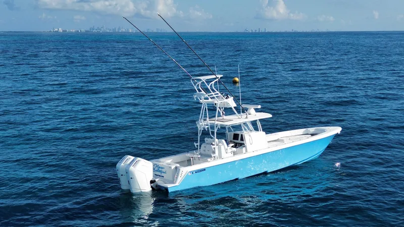 Slide: The Image of 2024 Contender 39 ST boat on open ocean with city skyline in background. - 14