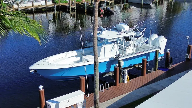 Slide: The Image of 2024 Contender 39 ST boat docked on a sunny waterfront. - 4