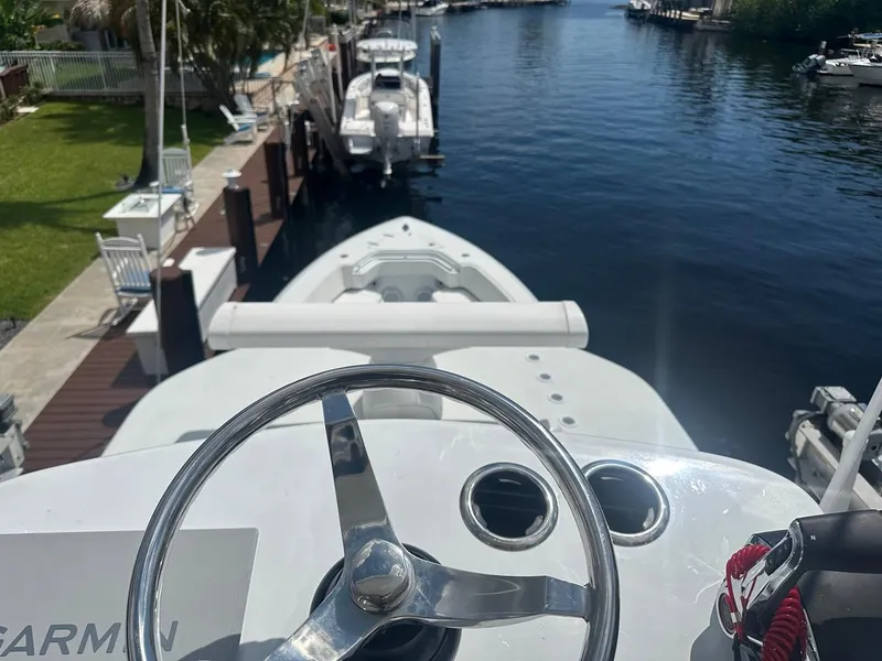 Slide: The Image of 2024 Contender 39 ST boat steering wheel with docked view. - 5