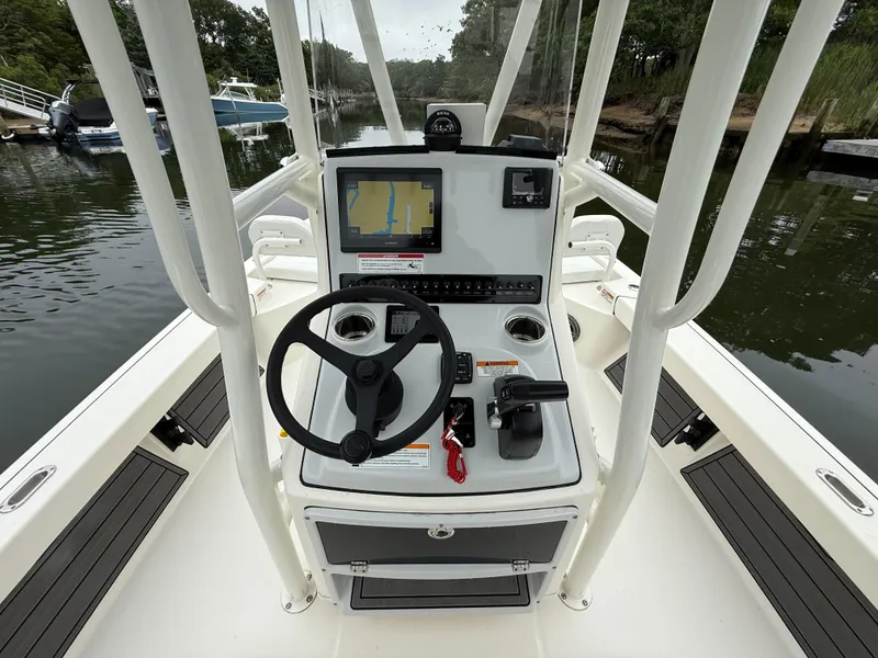 Slide: The Image of 2024 Pathfinder 2200 TRS boat console with steering wheel and navigation screen. - 13
