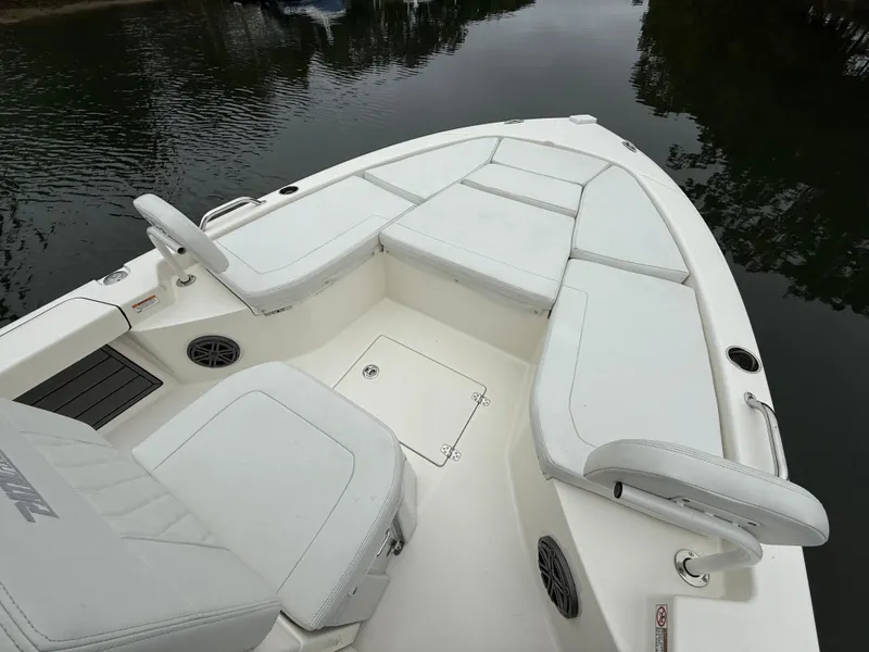 Slide: The Image of 2024 Pathfinder 2200 TRS boat with spacious seating and sleek design on calm water. - 15