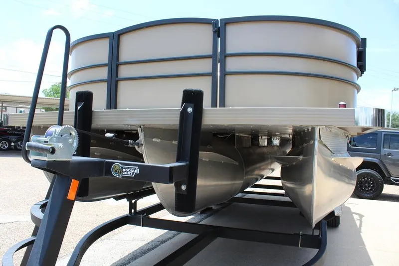 Slide: The Image of 2022 Massimo Marine P-23 TRITOON boat on trailer, showcasing pontoons and structure. - 12