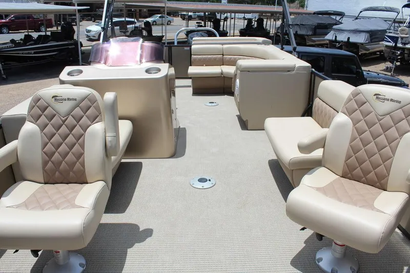 Slide: The Image of 2022 Massimo Marine P-23 TRITOON boat interior with beige seating and steering console. - 3