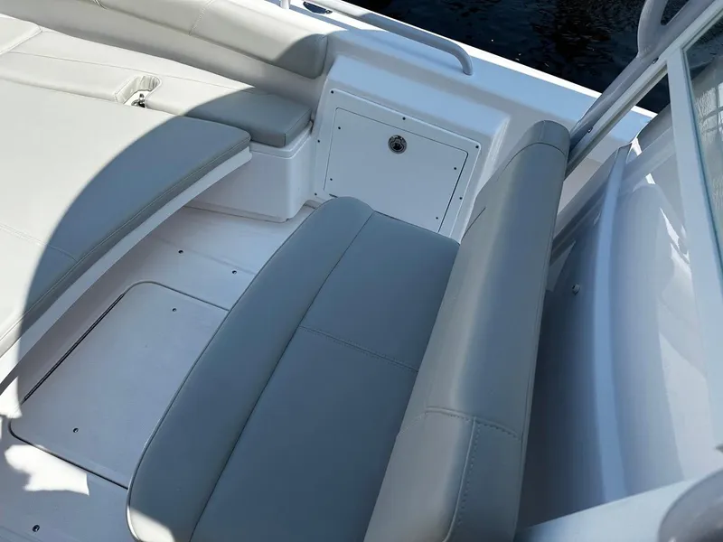 Slide: The Image of 2023 Everglades 243 Center Console boat interior with gray seating and storage compartment. - 11