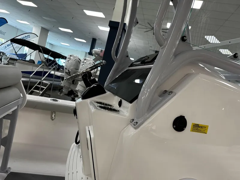 Slide: The Image of 2023 Everglades 243 Center Console boat interior with steering wheel and seating. - 3