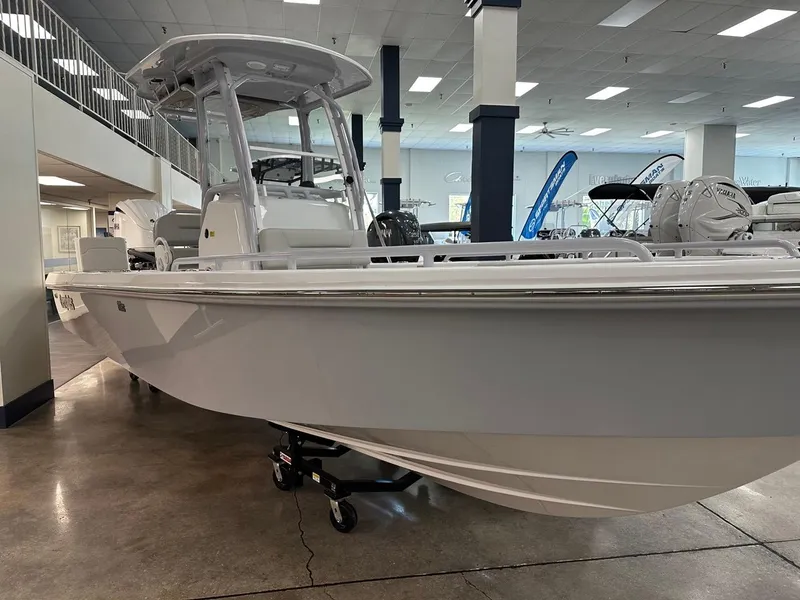 Slide: The Image of 2023 Everglades 243 Center Console boat displayed in showroom, side view. - 4