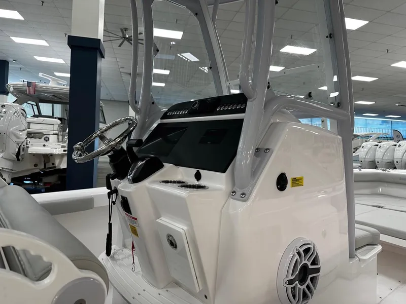 Slide: The Image of 2023 Everglades 243 Center Console boat interior with steering wheel and control panel. - 5