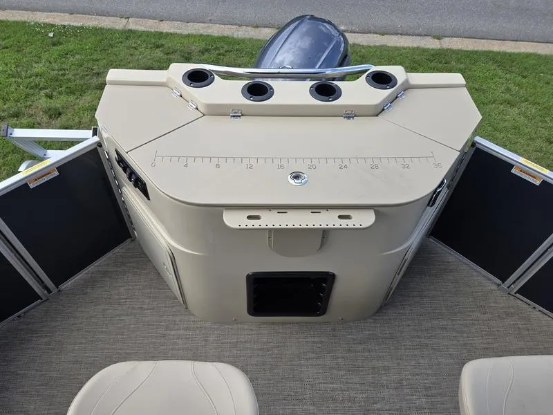 Slide: The Image of 2025 Godfrey Sweetwater 2086 FS Sport Tube boat console with cup holders and measurement markings. - 13