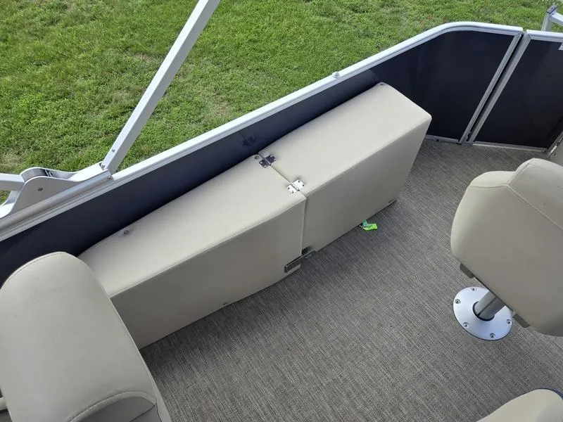 Slide: The Image of Interior of 2025 Godfrey Sweetwater 2086 FS Sport Tube boat, featuring beige seating and carpet. - 14