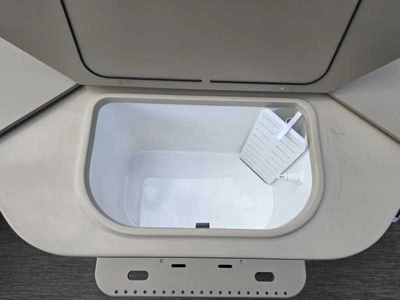 Slide: The Image of Open storage compartment on 2025 Godfrey Sweetwater 2086 FS Sport Tube boat. - 16