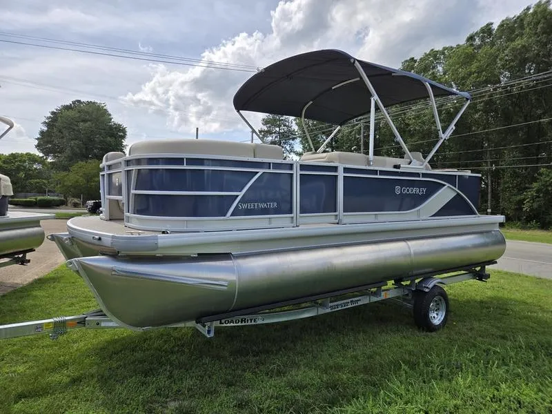 Slide: The Image of 2025 Godfrey Sweetwater 2086 FS Sport Tube pontoon boat on trailer, parked outdoors. - 4